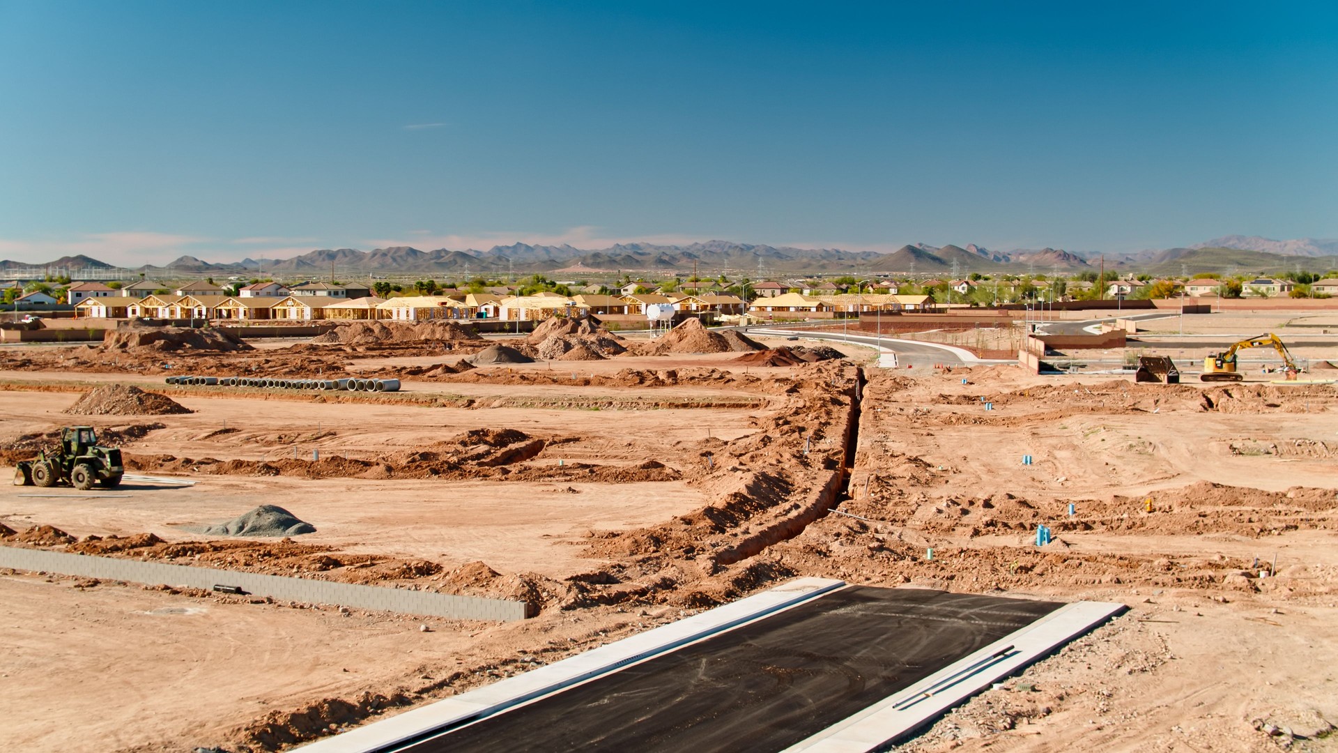 Low Drone Shot of Graded Land and Construction Frames in Peoria, AZ
